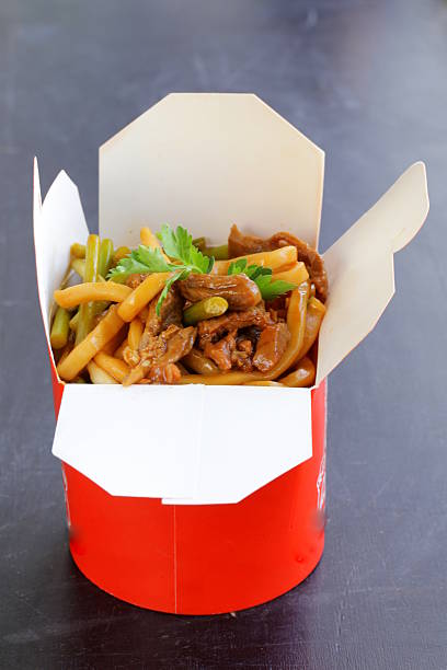 istock Chinese noodles with vegetables and meat in cardboard box 465134541