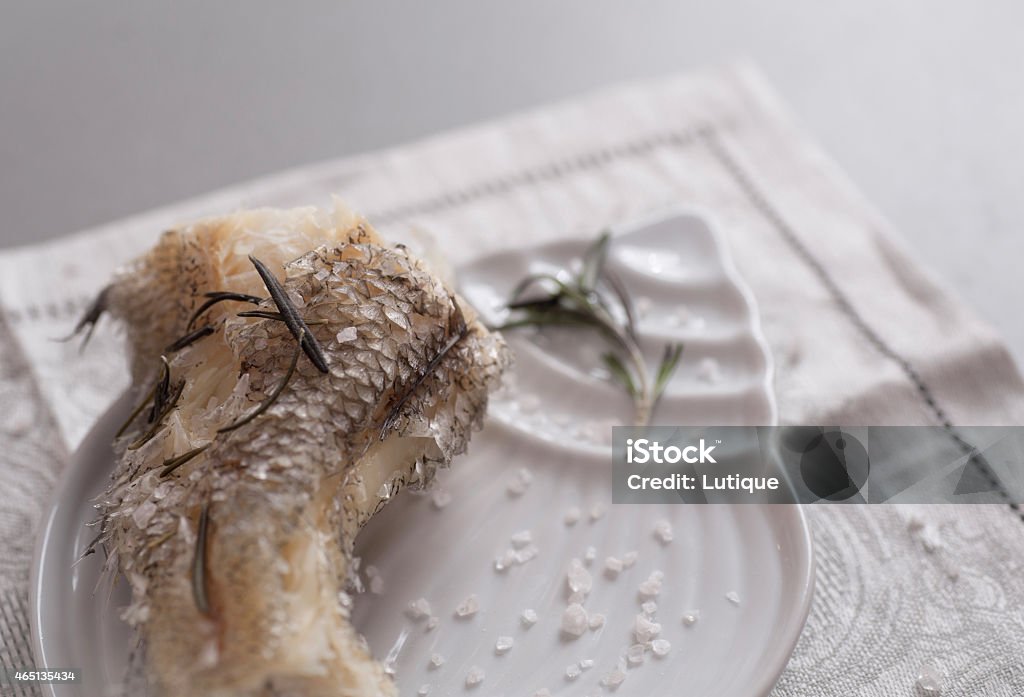 Cooked on steam grenadier fish with sea salt Cooked on steam grenadier fish with sea salt and fresh rosemary on white plate. 2015 Stock Photo