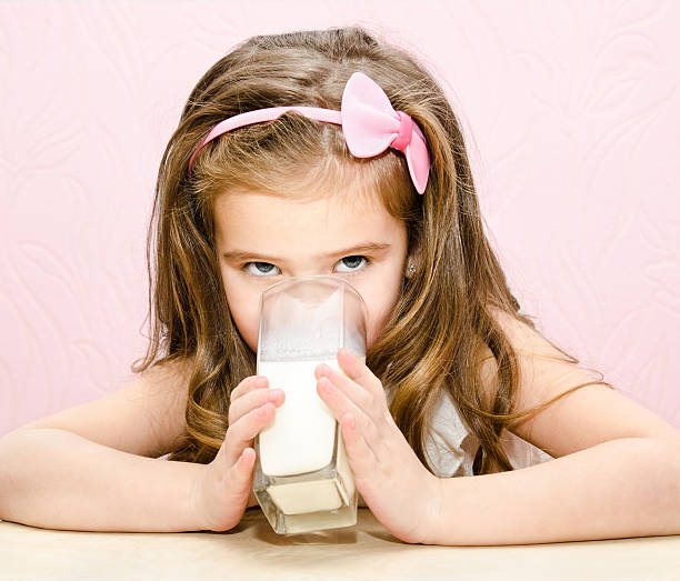istock Beautiful little girl drinking milk 465135839