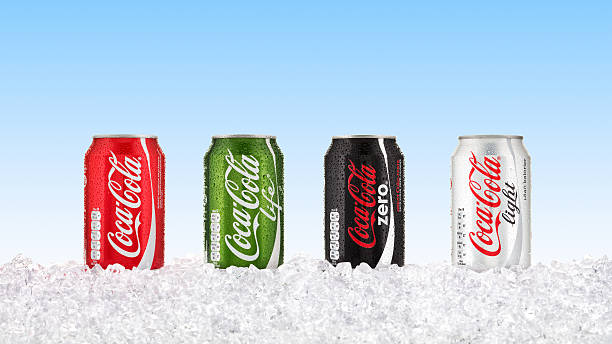 Coca Cola cans Goteborg, Sweden - February 15, 2015: Four varieties of Coca Cola in cans standing on ice with condensation droplets on. coke zero photos stock pictures, royalty-free photos & images