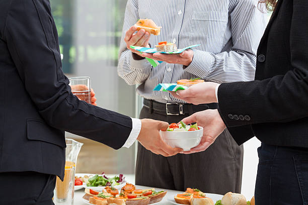 Business breakfast in the office Managers are eating breakfast in the office and discuss about finances tail coat photos stock pictures, royalty-free photos & images