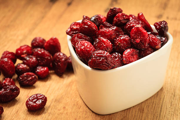 istock Dried cranberry fruit in bowl on table. 465137122