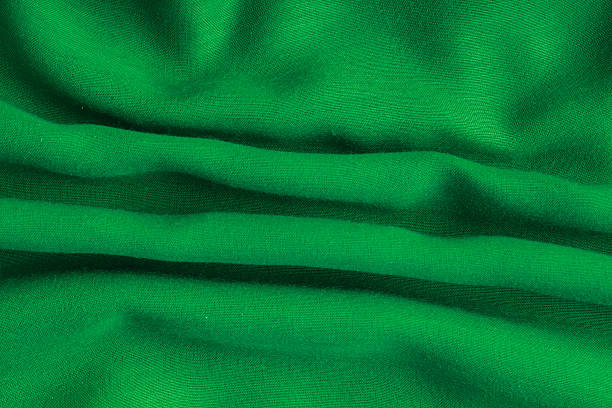istock green background abstract cloth wavy folds of textile texture 465137603