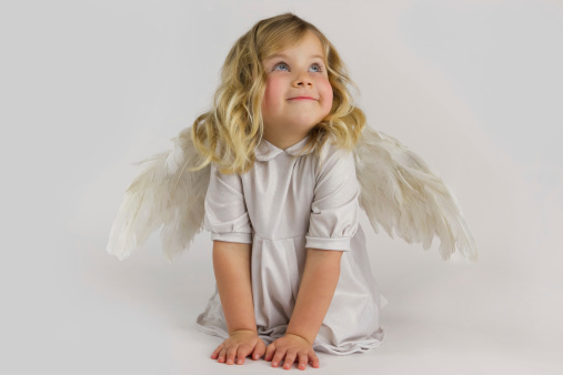 Happy Valentine's Day. Little baby cupid, beautiful girl in white dress holding paper heart isolated over white studio background. Concept of childhood, imagination, fantasy, happiness, holidays