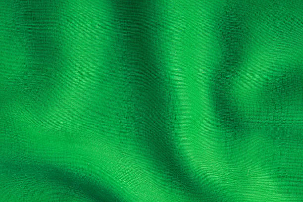 istock green background abstract cloth wavy folds of textile texture 465138157