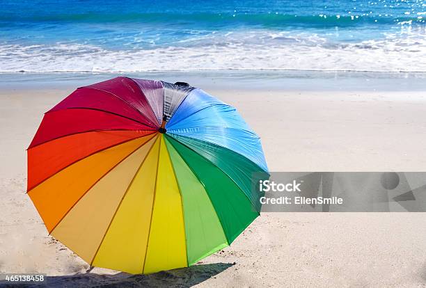 Rainbow Umbrella By The Ocean Stock Photo - Download Image Now - Beach, Rainbow, 2015