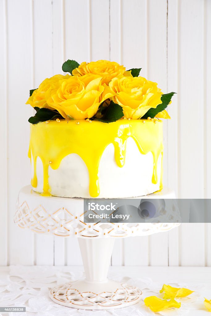 Homemade carrot cake decorated with yellow roses and glaze. Homemade carrot cake decorated with yellow roses and glaze.Homemade carrot cake decorated with yellow roses and glaze. 2015 Stock Photo
