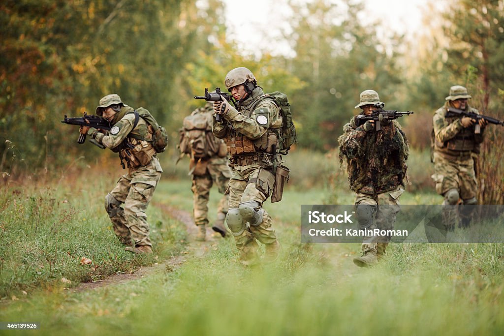 group of soldiers engaged in the exploration area group of rangers was ambushed and returned fire leads Military Stock Photo