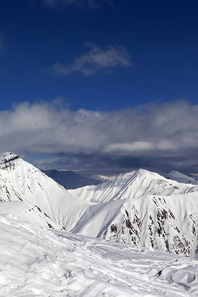 istock Ski slope and beautiful snowy mountains 465140055