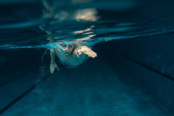 A white male swimmer in the pool stock photo