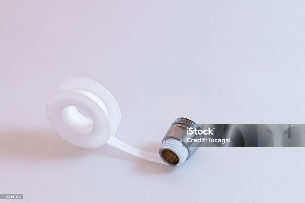 teflon tape or plumber tape applicated on a thread teflon tape or plumber tape applicated on a thread white background Adhesive Tape Stock Photo