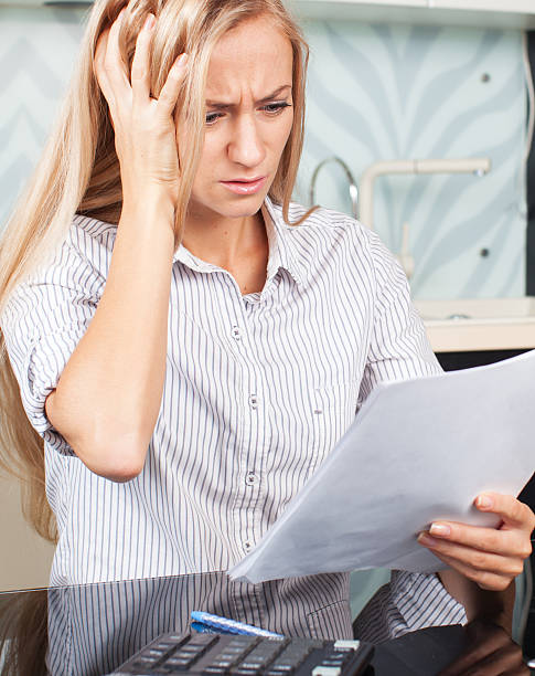 istock Sad woman looks at the bill 465141906