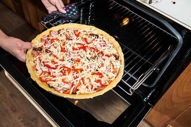 istock Raw Fresh Homemade Pizza Baking in Electric Oven. 465142048