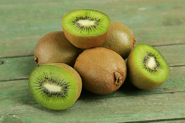 istock Kiwi fruit on green wooden background 465143010