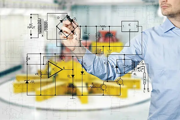 Photo of electrical engineer draws a diagram of a circuit