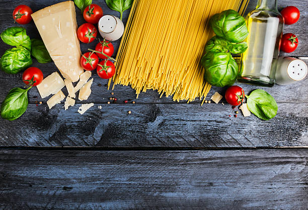 istock Raw spaghetti with cooking Ingredients  on blue rustic wooden background 465143796