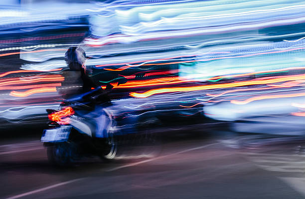 istock Scooter in a Blurred City Scene 465144442