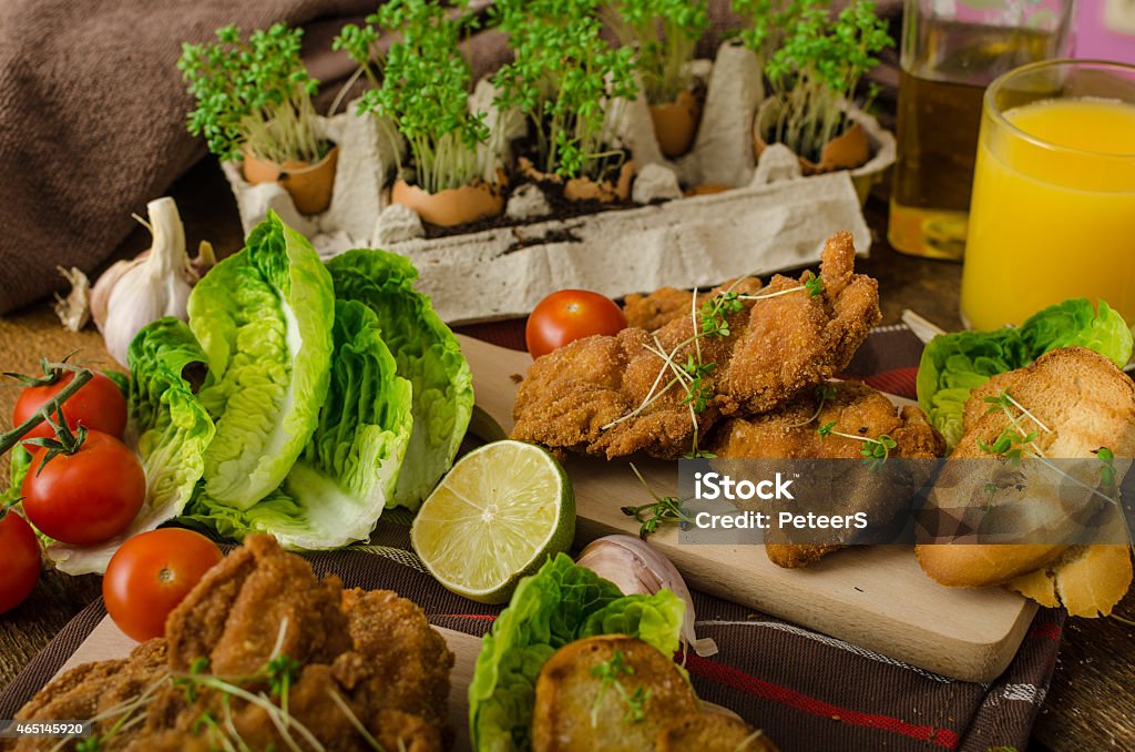 Mini cutlets - schnitzels Mini cutlets - schnitzels of chicken legs meat and fresh salad and toasted baguette 2015 Stock Photo