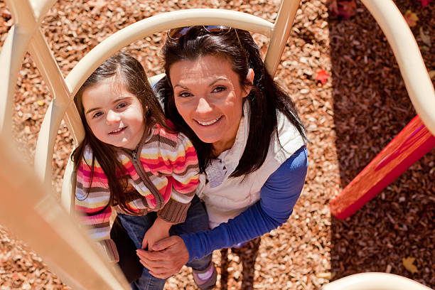 Mom and daughter playing on jungle gym 9 stock photo