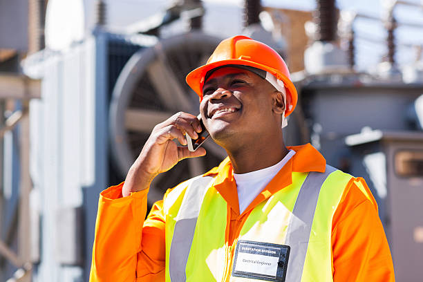 istock afro american electrical engineer talking on smart phone 465146776