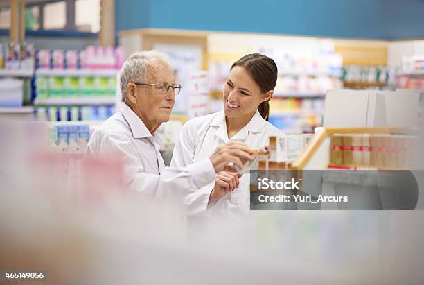 Making Sure Her Customers Are Taken Care Of Stock Photo - Download Image Now - Pharmacy, Standing, Talking