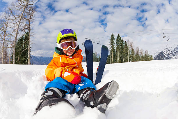 istock Sitting on snow boy in ski mask and helmet 465150244