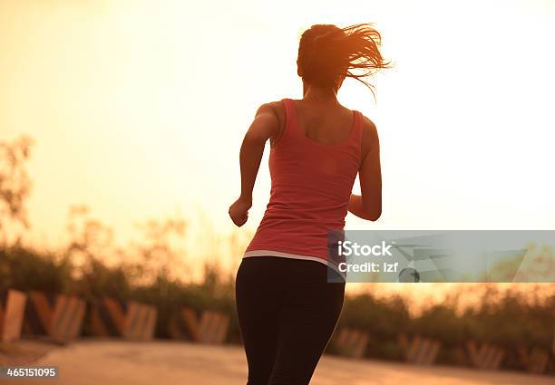 Woman Going For A Morning Run At Sunrise Stock Photo - Download Image Now - Active Lifestyle, Activity, Adult