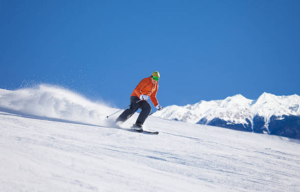 istock Sportsman in ski mask sliding fast while skiing 465151194