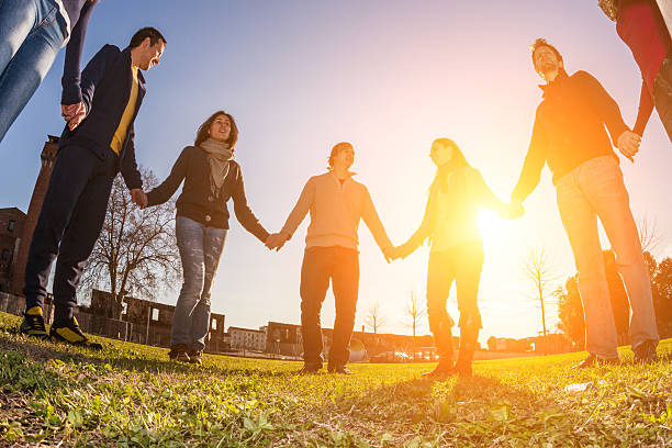 istock Multiracial Young People Holding Hands in a Circle 465151829