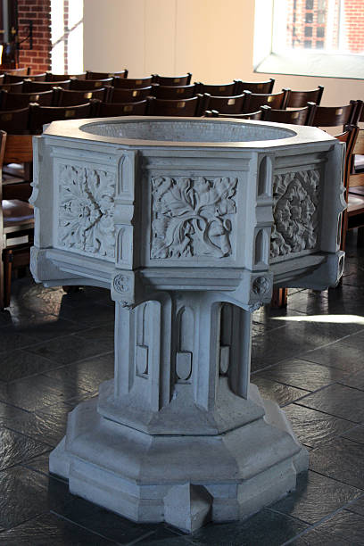 Ornate Baptismal Font in a Church This ornate baptismal font is ready for the Christian rite of baptism. baptismal font stock pictures, royalty-free photos & images