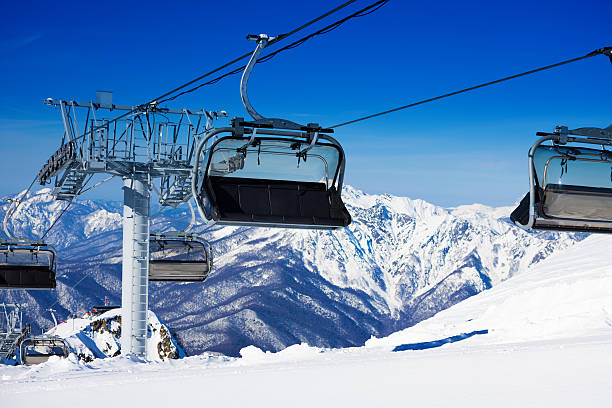 istock Chairs on chairlift ropeway in winter mountains 465153678