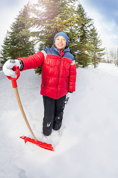 istock Arabian boy with shovel in winter during day 465153734
