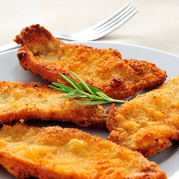 spanish escalopa de pollo a la milanesa, breaded chicken fillets a plate with some spanish escalopa de pollo a la milanesa, breaded chicken fillets scaloppini stock pictures, royalty-free photos & images