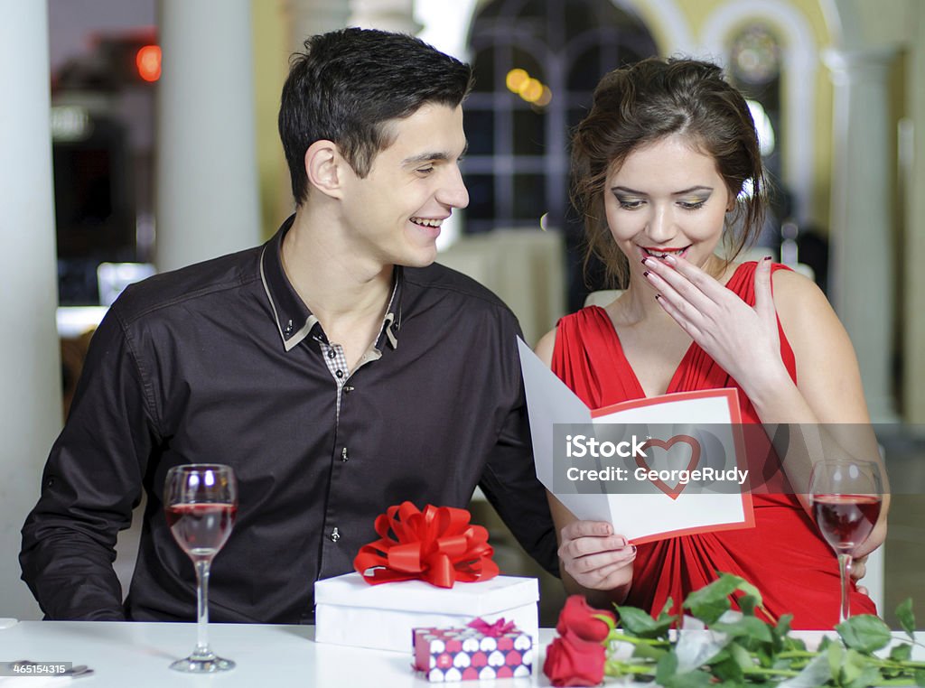 love. Valentines Day Young couple in love make a present to each other on Valentine's Day. Adult Stock Photo
