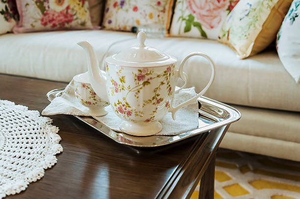 ceramic teapot and cups on a tray in living room