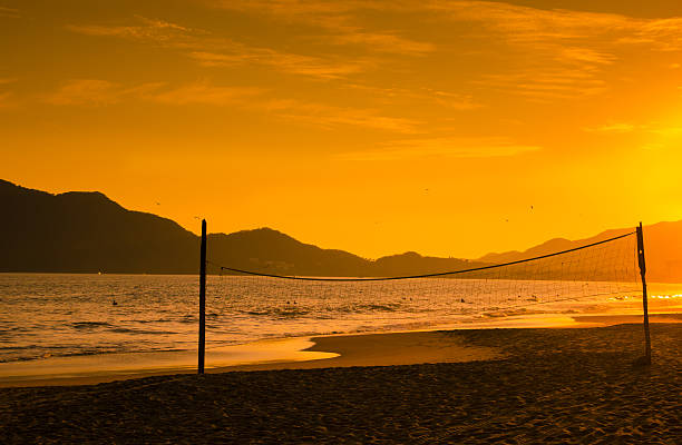 istock Volleyball net silhouetted by a firey sunset 465156634
