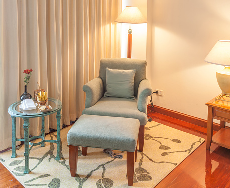 Relaxing corner, Reclining armchair, ottoman and table in hotel accommodation bedroom