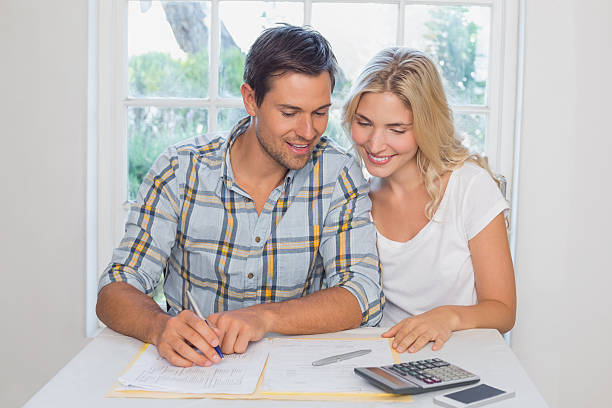 istock Couple with financial documents and calculator at home 465157874