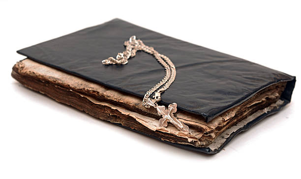 istock Religion. Cross with chain against a old book 465158541