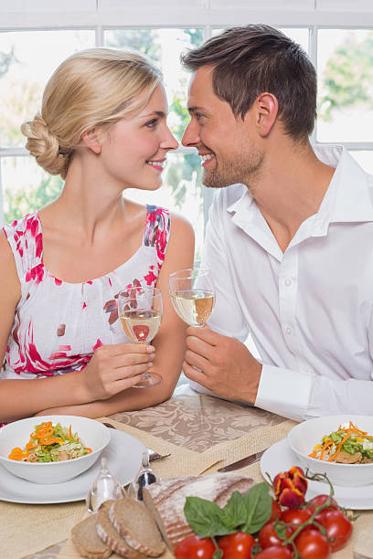istock Loving couple with wine glasses looking at each other 465159546