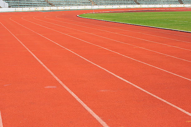 istock Orange racecourse with white line and green yard 465159853