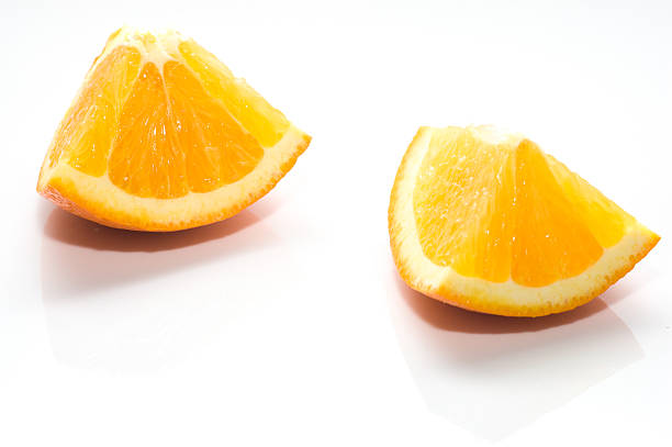 istock Two pieces of orange fruit isolated on white background 465160170