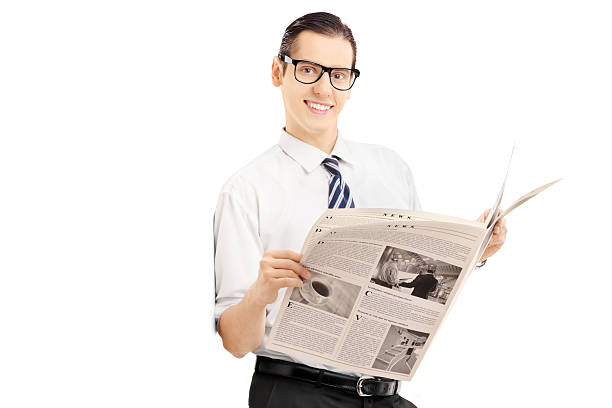 istock Smiling businessman leaning against wall and holding a newspaper 465160513