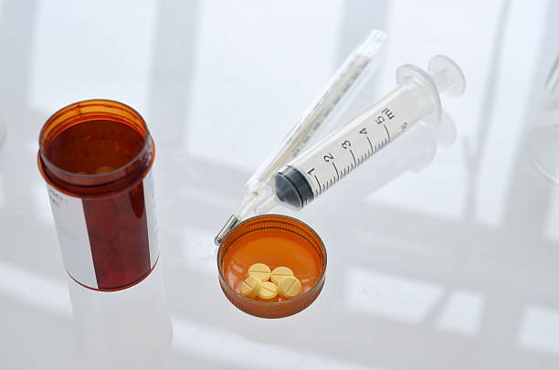 istock pills with pill bottle and syringe, thermometer 465160651
