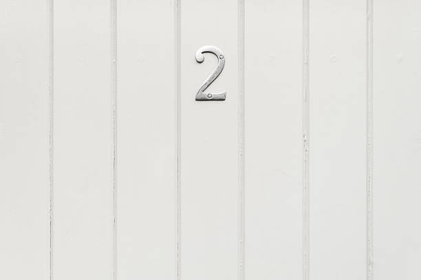 Background: wood panel door with number 2 sign stock photo