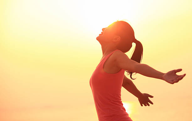 istock cheering woman open arms under  sunrise on beach 465162157