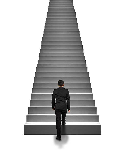 Rear view businessman climbing on stairs isolated in white stock photo