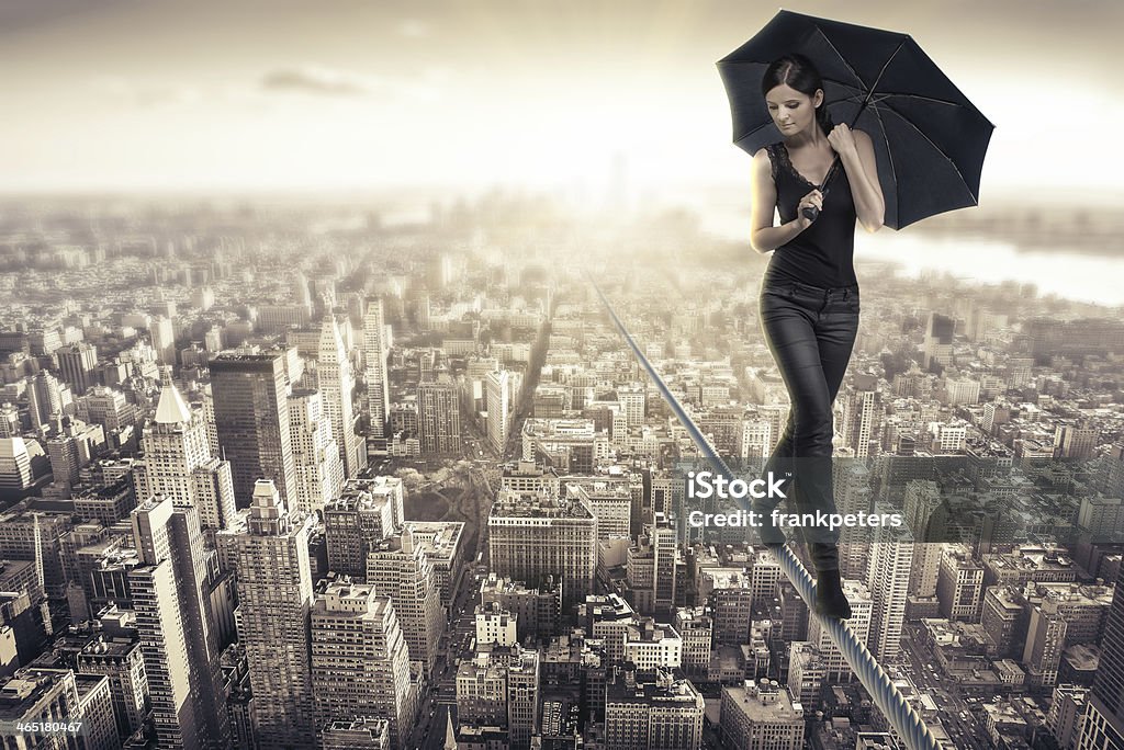 balance woman walking on a rope over manhattan Women Stock Photo