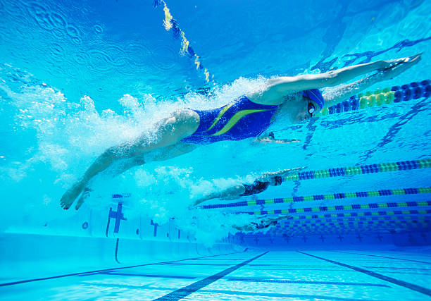 istock Young female professional participants racing in pool 465180579