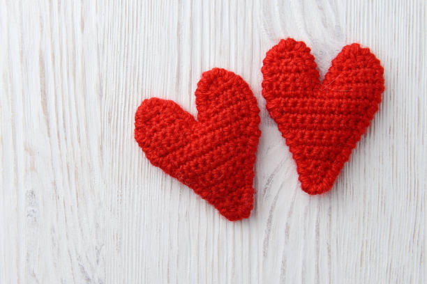 istock red hearts on white wooden background 465184501